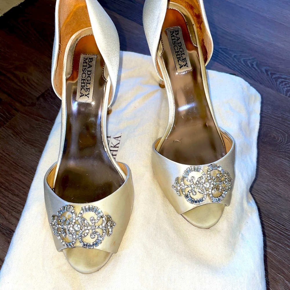 Peep-toe d'Orsay pump featuring rhinestone brooch